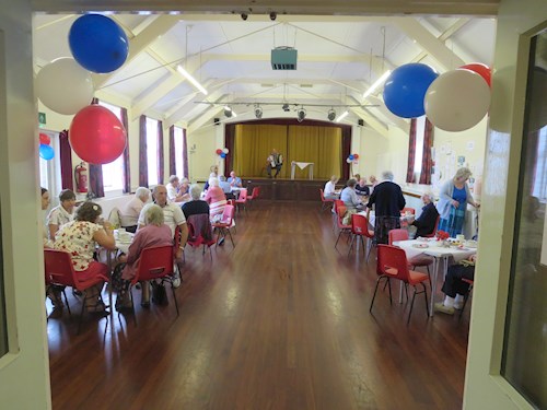 Picture in the Parish Hall showing the cream tea being served